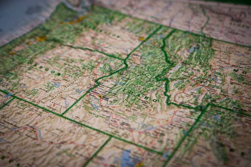 A compass resting on a map beside a printed declination diagram